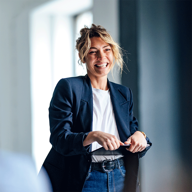 Lady standing smiling holding a tablet