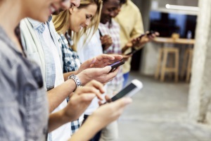 line of people looking at their phones