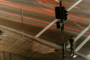 Man waiting to cross the road at a traffic light